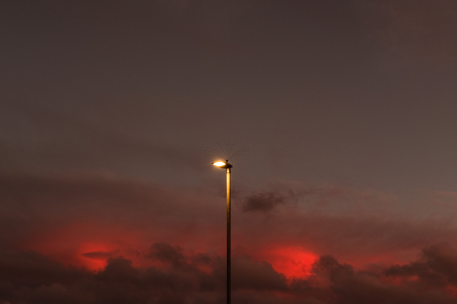 Sunset cloudscape behind street light in car park at Tesco, Seaton 14_10_22 2