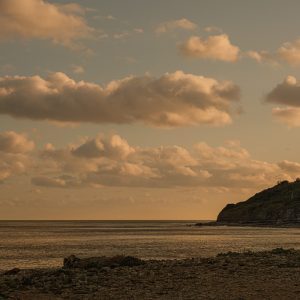 Cloudscape and silhouette of Seven Rock Point in late light from Monmouth Beach, Lyme Regis 05_08_23