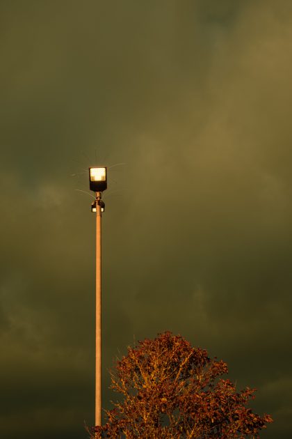 Lit streetlights against a stormy sky in the Tesco car park, Seaton 05_12_23 2