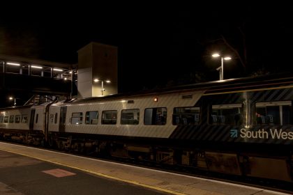 Axminster Railway Station after dark with train at platform 2 28_11_23 1 Enhanced NR
