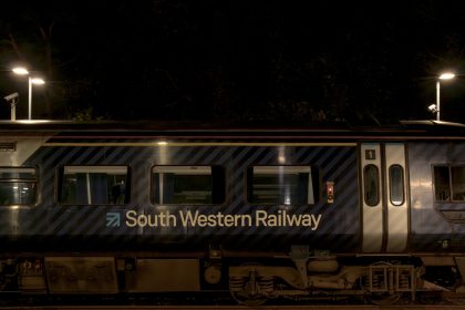 Axminster Railway Station after dark with train at platform 2 28_11_23 2 Enhanced NR