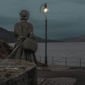 Mary Anning statue and lamp light early morning above Church Cliff Beach, Lyme Regis 16_08_22