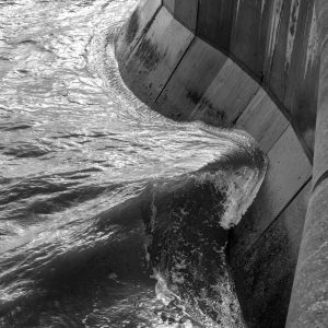 Wave curling around Church Cliff Walk sea wall, Lyme Regis 02_02_21 mono