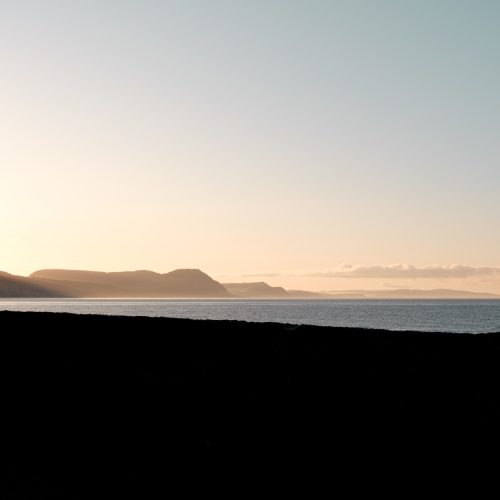 Sunrise over the coast and sea through the dip in the sea wall on Gun Cliff Walk Lyme Regis 04_05_24 1 pano
