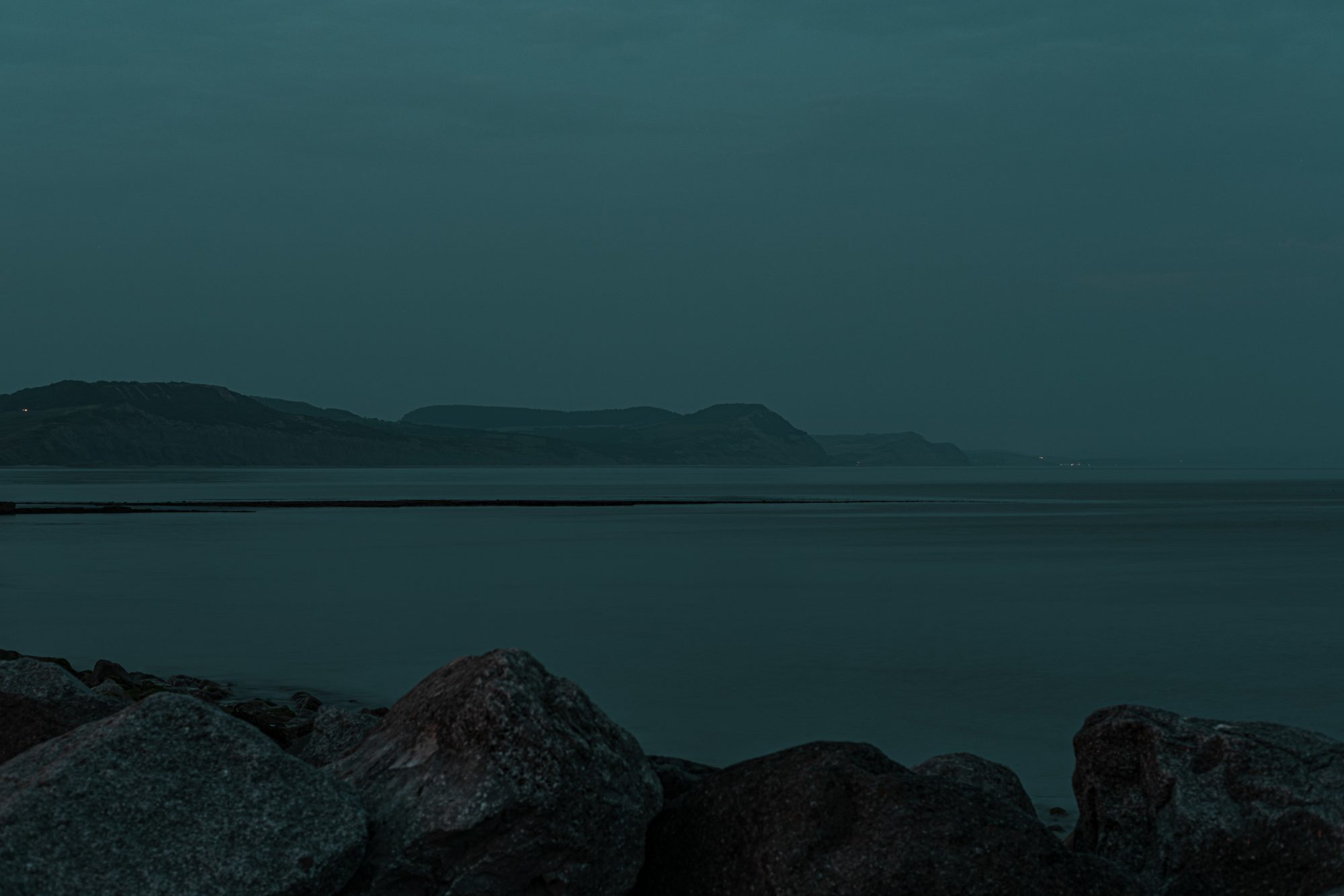 Twilight view over the coast and sea from the sea wall beside Cobb Gate Beach Lyme Regis 31_07_24