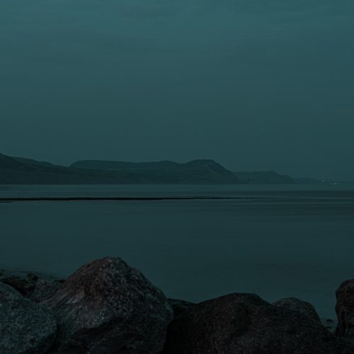 Twilight view over the coast and sea from the sea wall beside Cobb Gate Beach Lyme Regis 31_07_24
