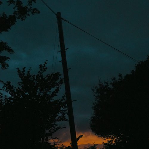 Leaning telegraph pole against a dark twilight sky at Timber Vale Caravan Park Lyme Regis 14_07_23
